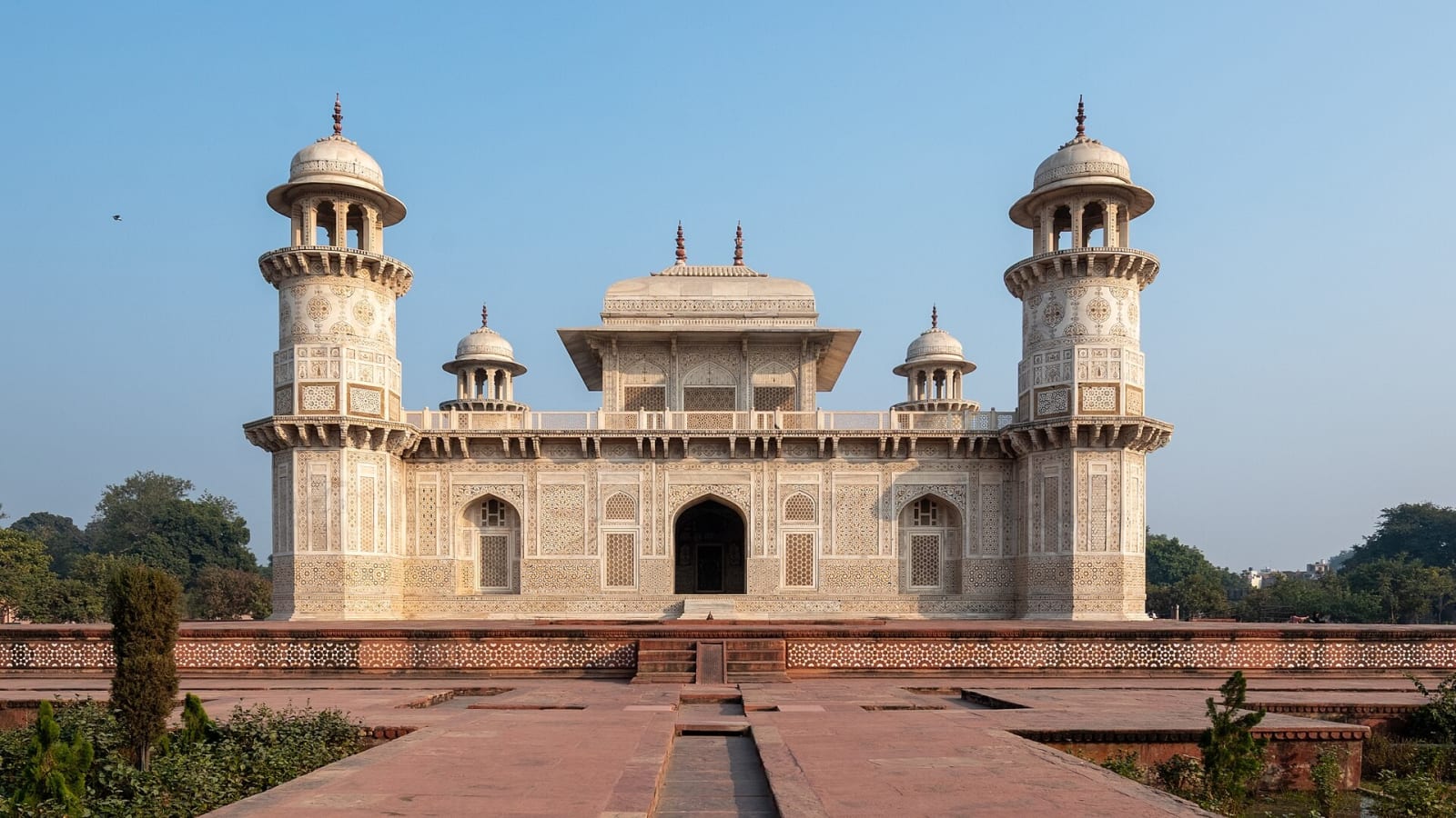 White marble tomb of Itimad-ud-Daulah with two corner minarets and a garden path