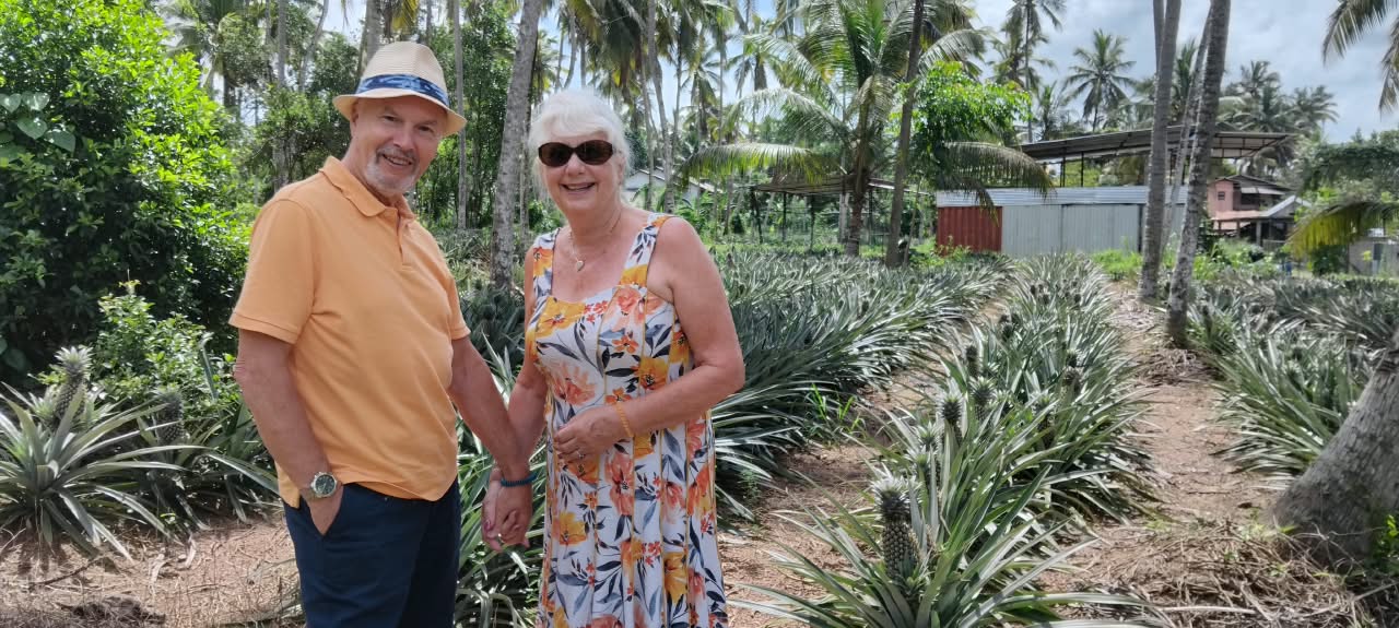 Travelers Enjoying Fresh Roadside King Coconuts