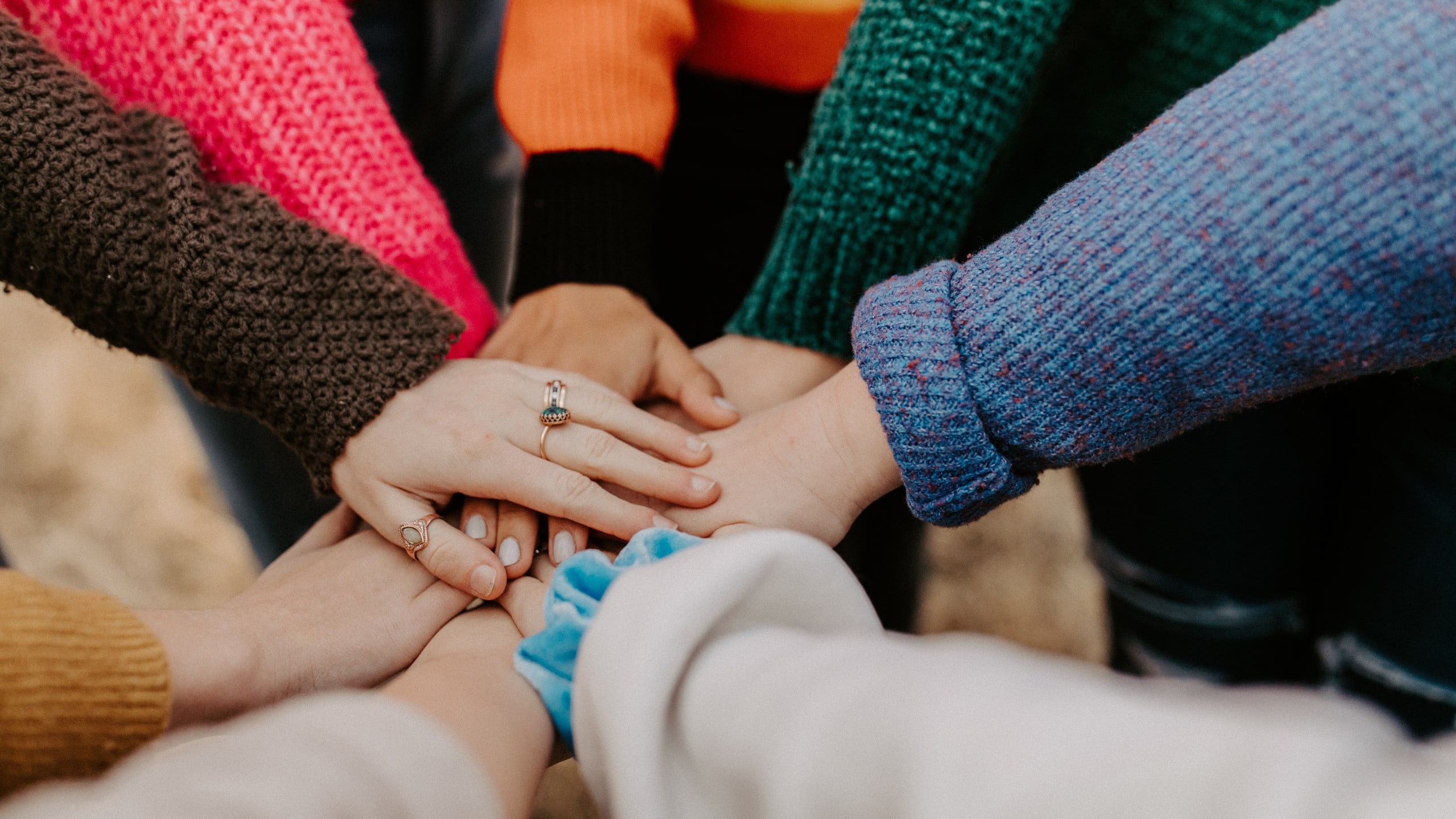 Hands stacked in a huddle