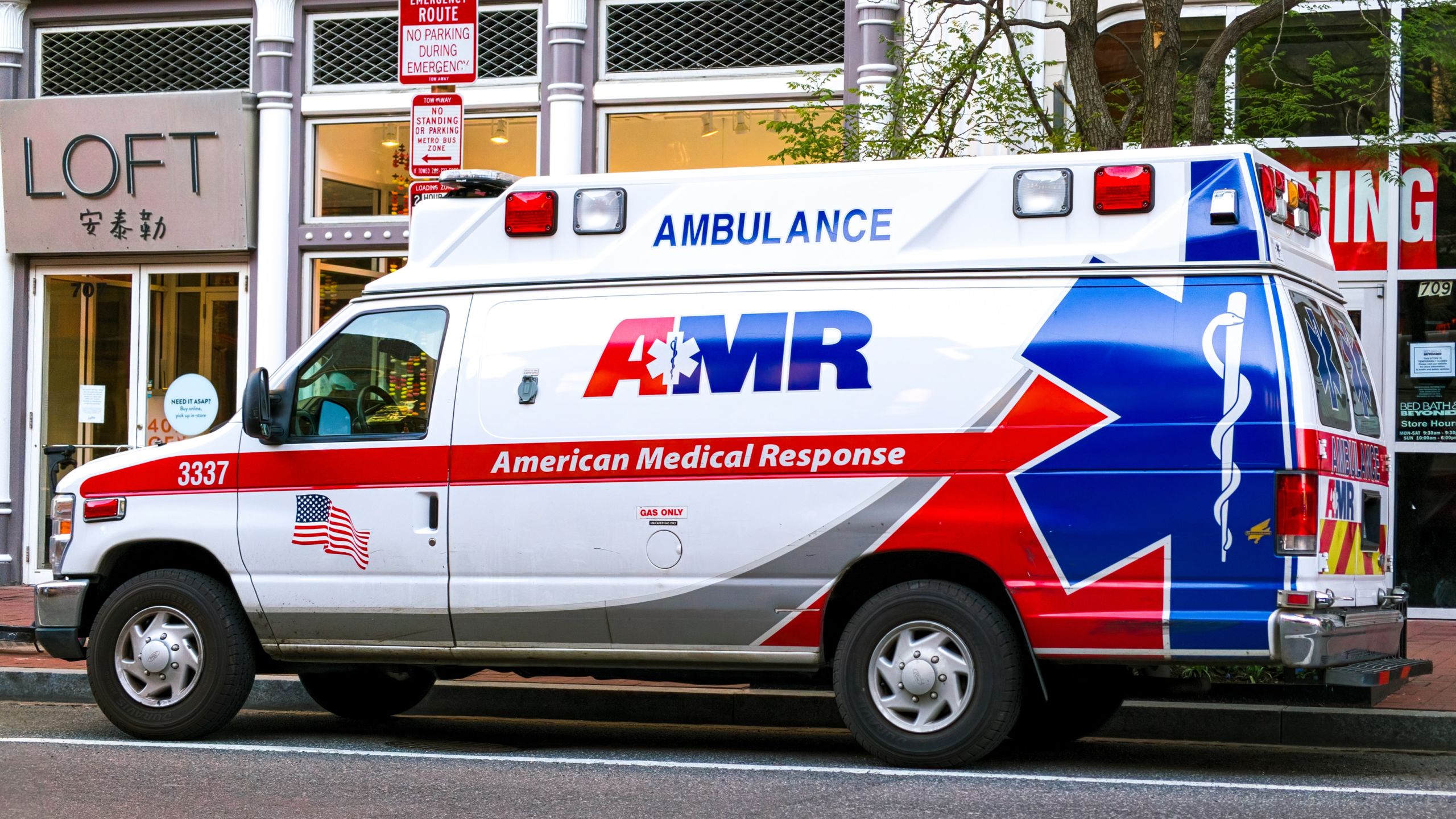 A first responder ambulance parked outside of Ann Taylor Loft in China Town, Washington DC during the Coronavirus pandemic.
