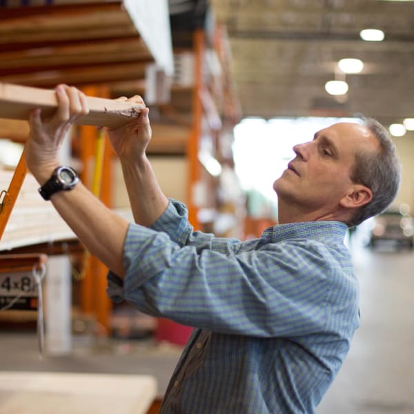 Worker inspecting lumber