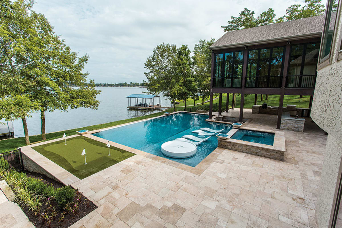 Smooth, milky Ivory Travertine brings the blue water and green landscape to life!