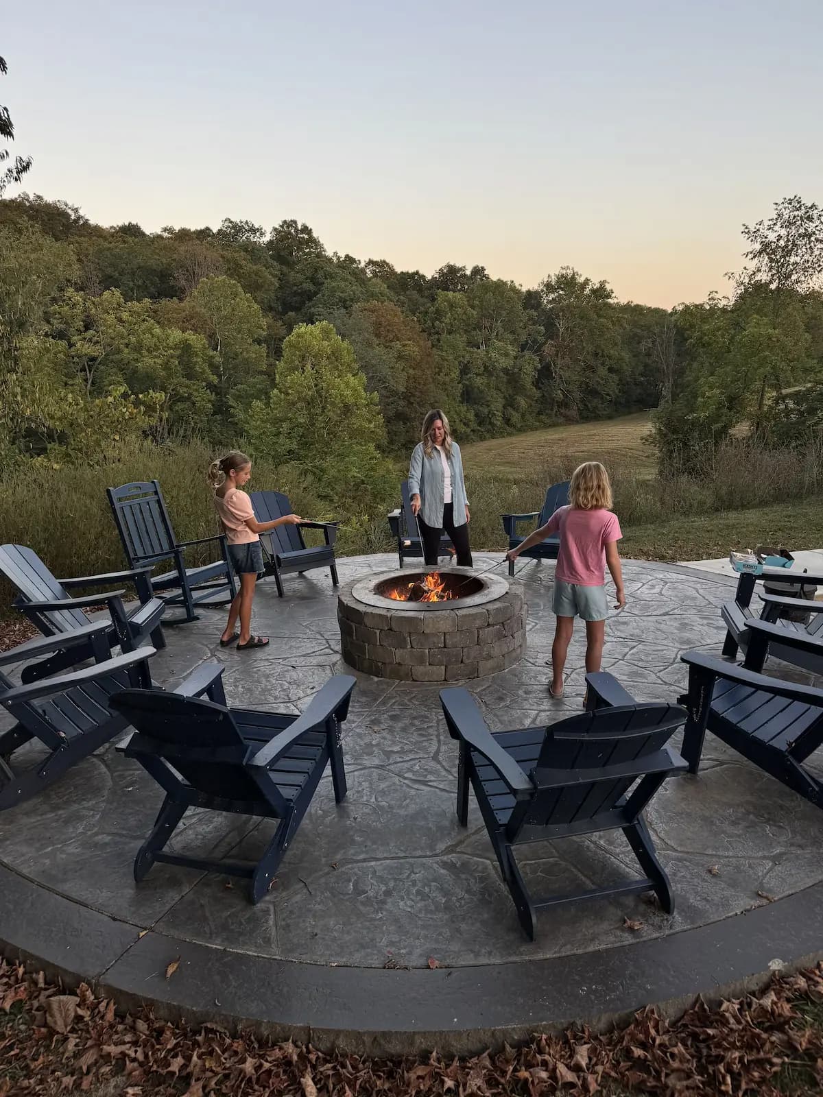 Family at fire pit — Pool House Lodge