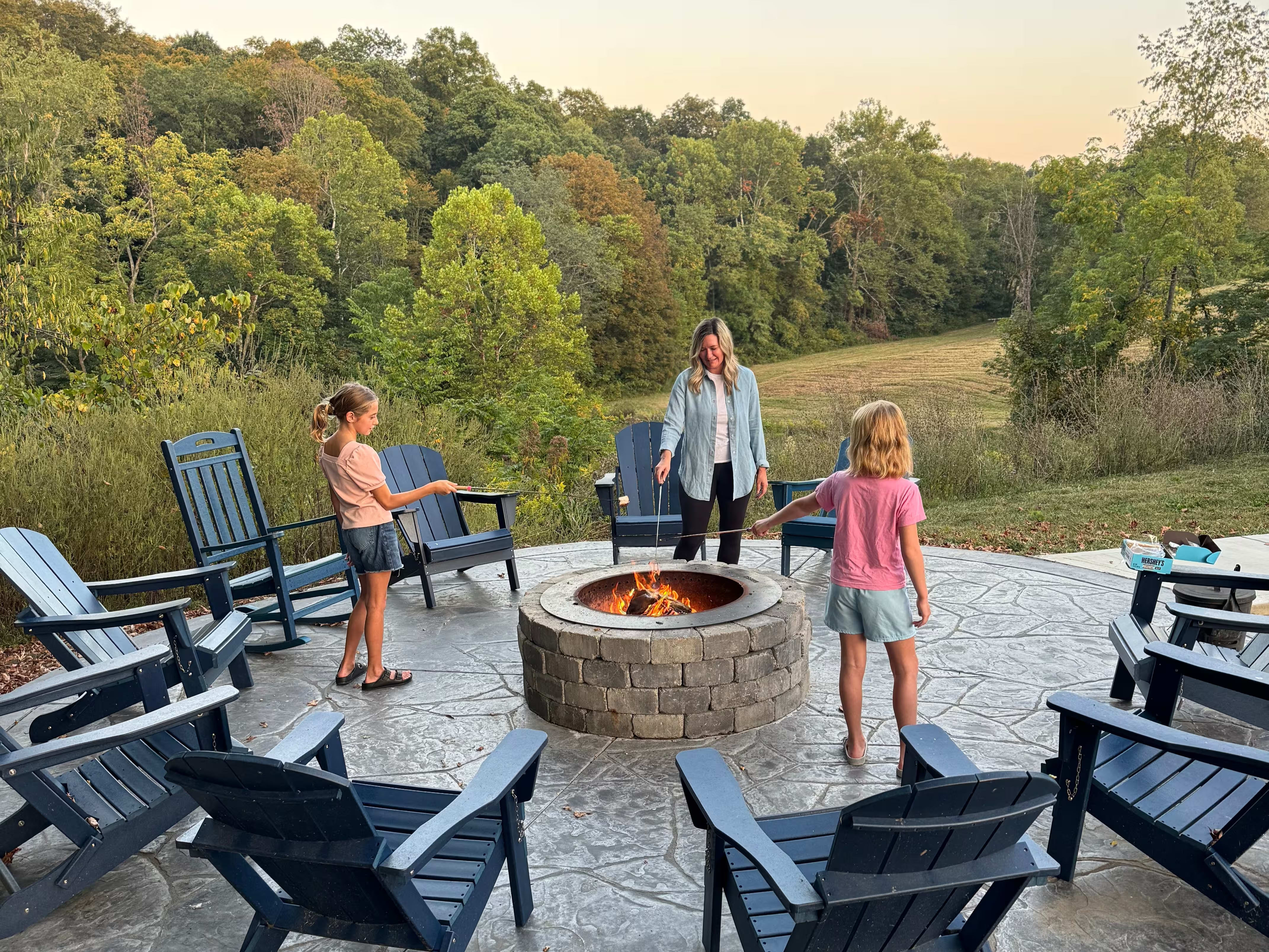 Family gathered around the firepit at Pool House Lodge in Hocking Hills Ohio