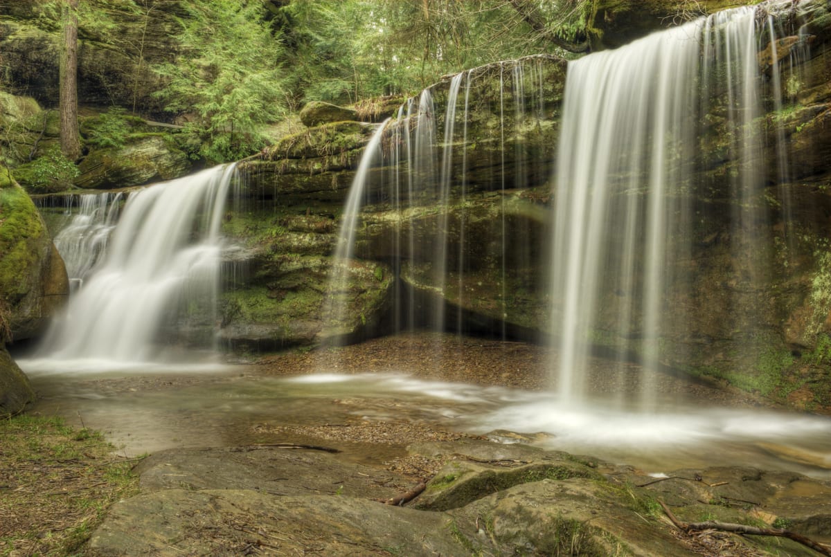 Cedar Falls waterfall in Hocking Hills Ohio surrounded by fall foliage