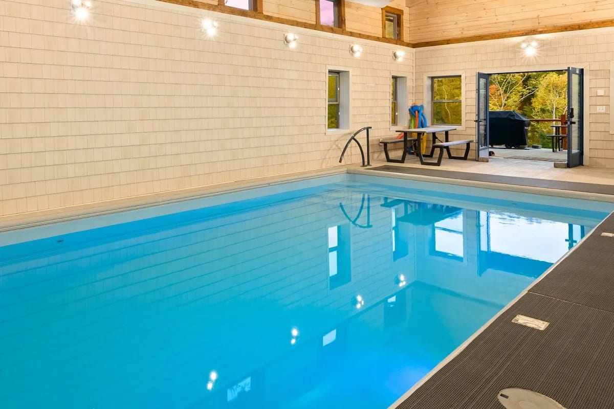 Private heated indoor pool at Pool House Lodge — Hocking Hills Ohio with wood beam ceiling