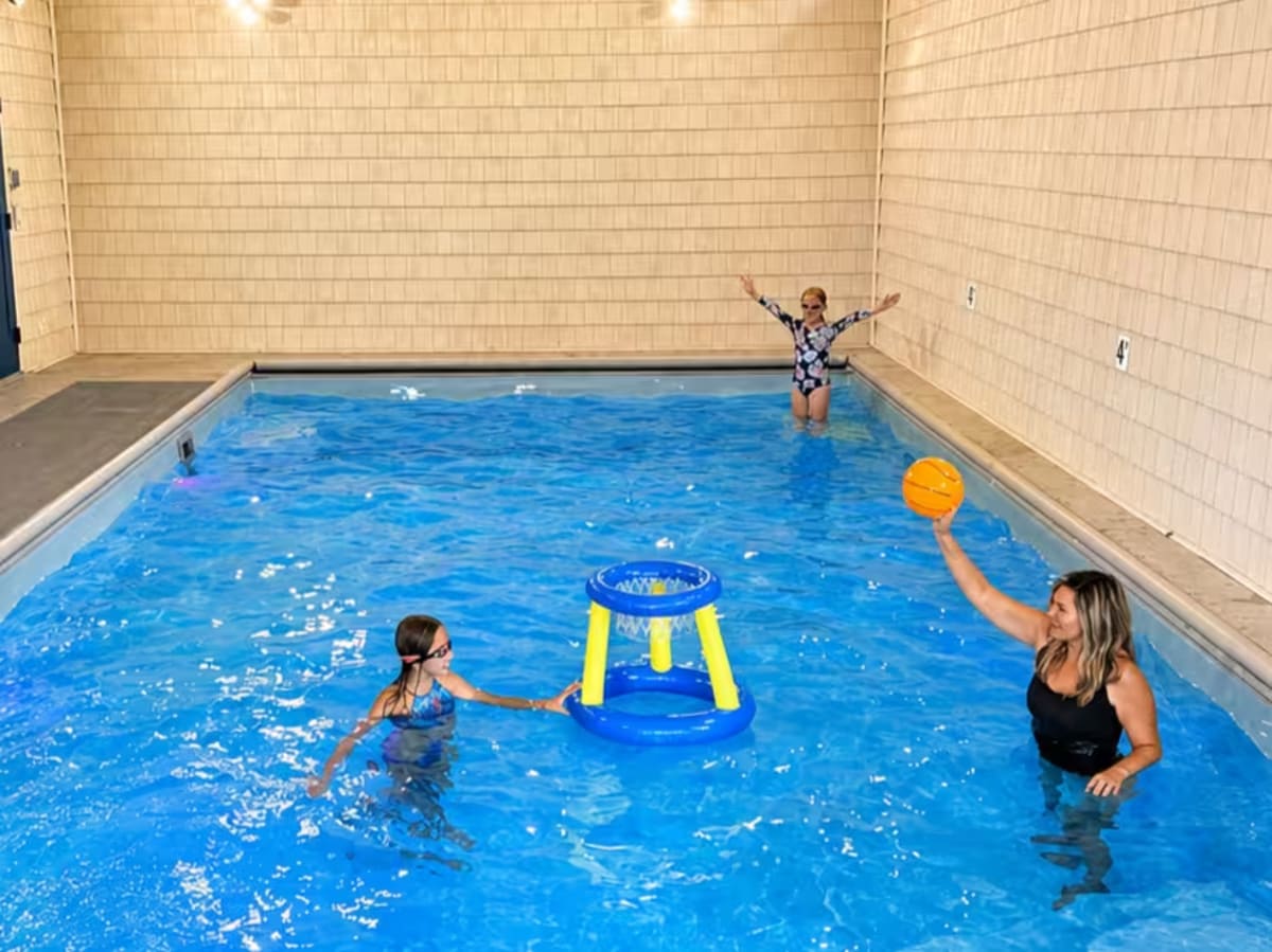Mom with kids in the private indoor pool at Pool House Lodge Hocking Hills