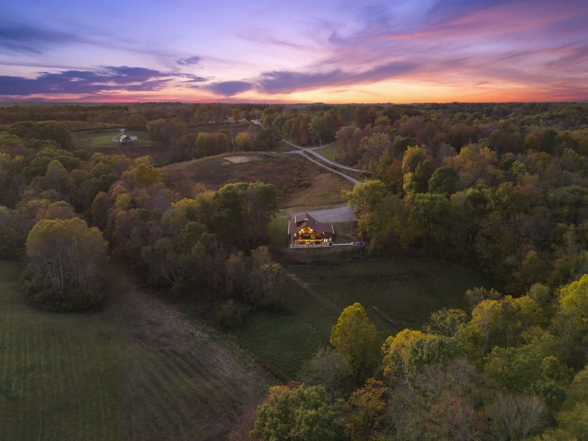 Aerial view of Pool House Lodge — 22 private wooded acres in Hocking Hills, Ohio at sunset
