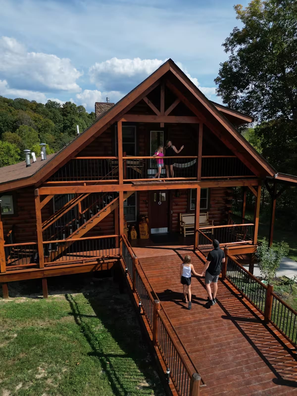 Family arriving at Pool House Lodge via wheelchair accessible ramp — Hocking Hills Ohio cabin