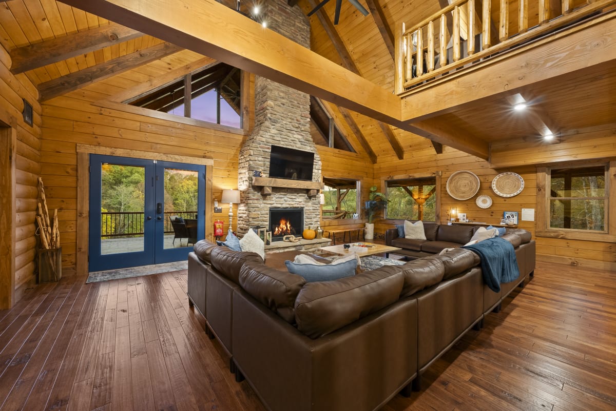Great room with stone fireplace at Pool House Lodge
