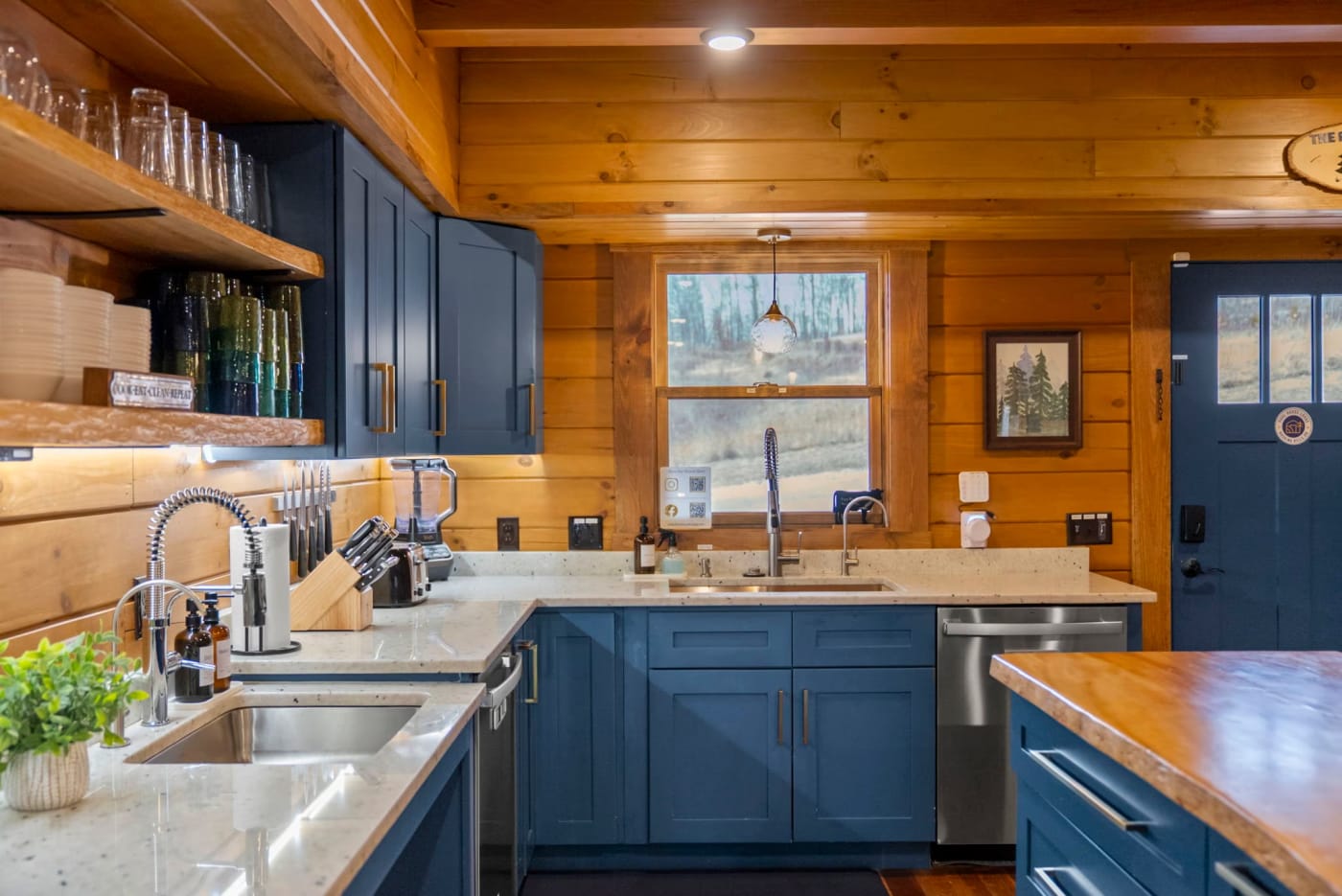 Chef's kitchen at Pool House Lodge — blue cabinets, granite counters, double dishwashers — Hocking Hills large group cabin