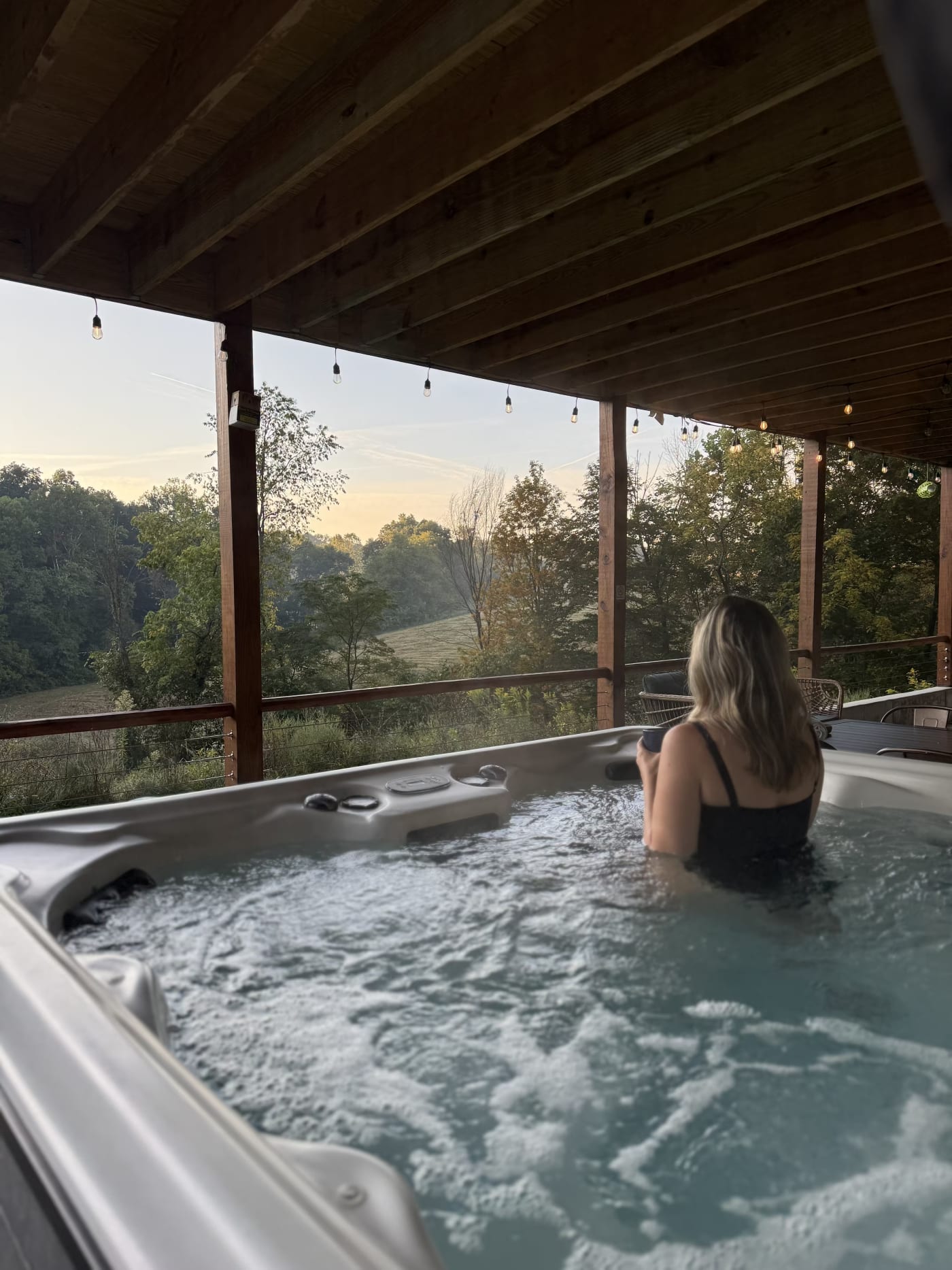 8-person outdoor hot tub on lower covered patio at Pool House Lodge Hocking Hills Ohio