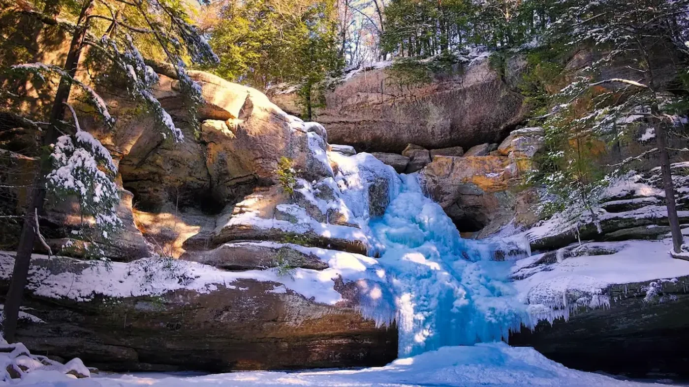 A frozen waterfall and snow-covered gorge in Hocking Hills, February