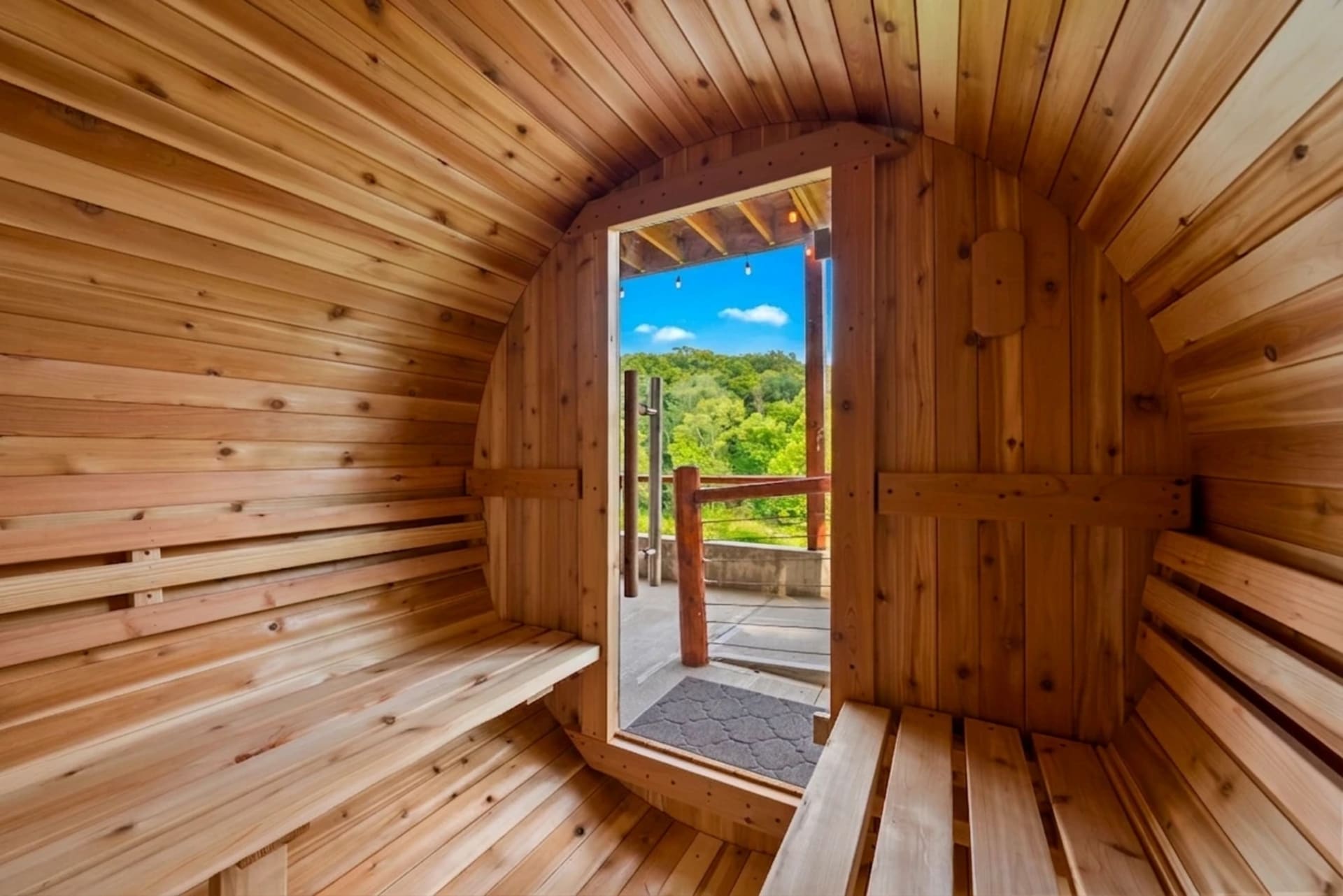 Cedar barrel sauna with rolling hill views at Pool House Lodge
