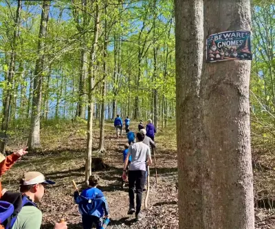 Family hiking the Gnome Trail at Pool House Lodge