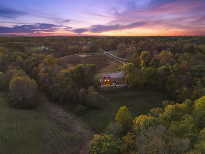 Pool house lodge aerial drone high altitude cabin rolling hills sunset