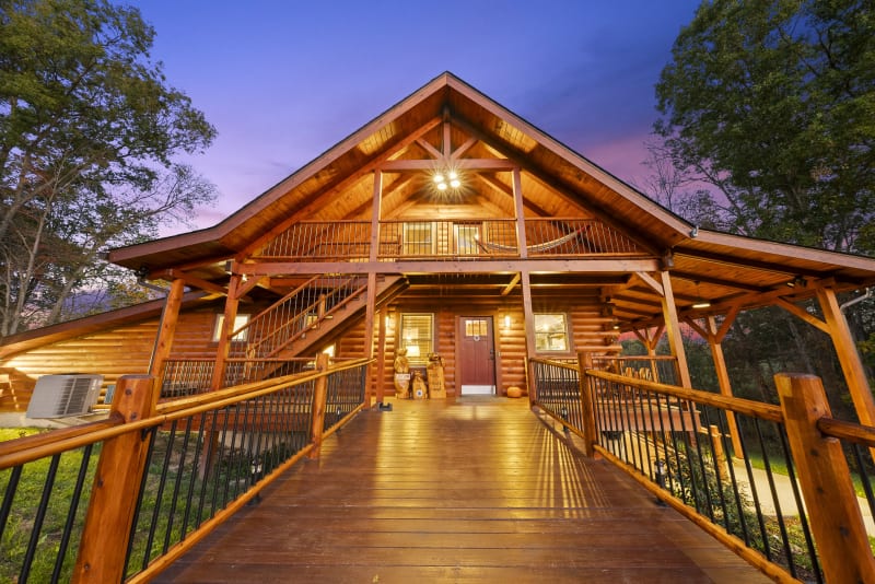 Pool house lodge cabin exterior dusk front walkway lights