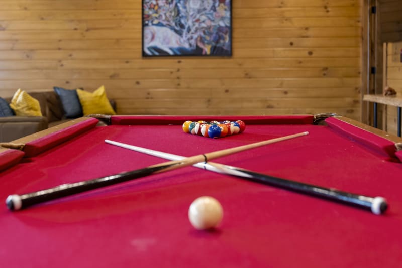Pool house lodge game room pool table red felt closeup