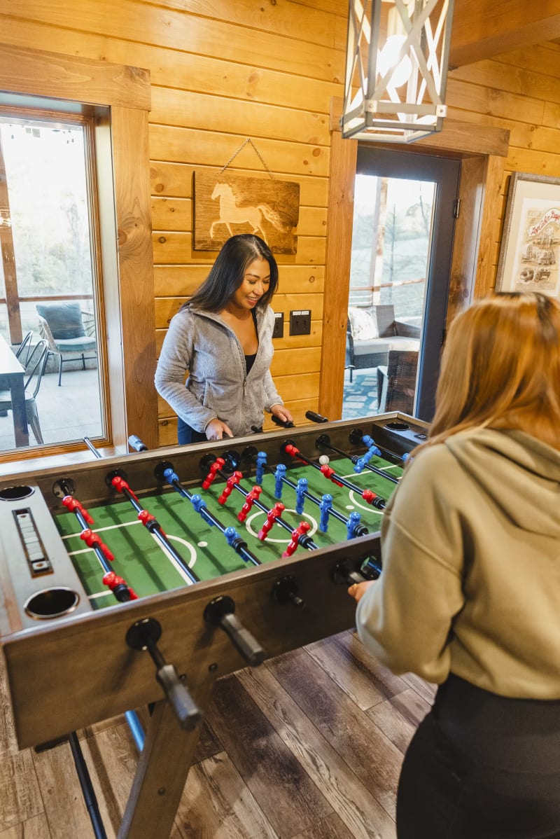 Pool house lodge guests playing foosball game room