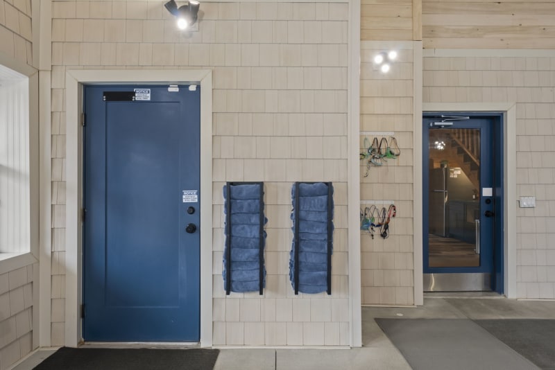 Pool house lodge indoor pool entry blue doors towel racks