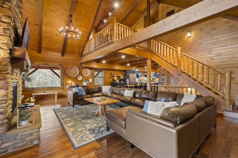 Pool house lodge living room open concept loft staircase chandelier