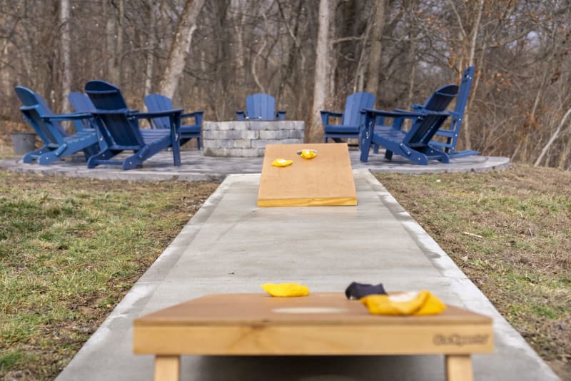 Pool house lodge outdoor cornhole boards fire pit background