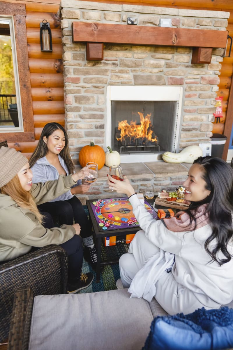 Pool house lodge outdoor stone fireplace friends drinks fall