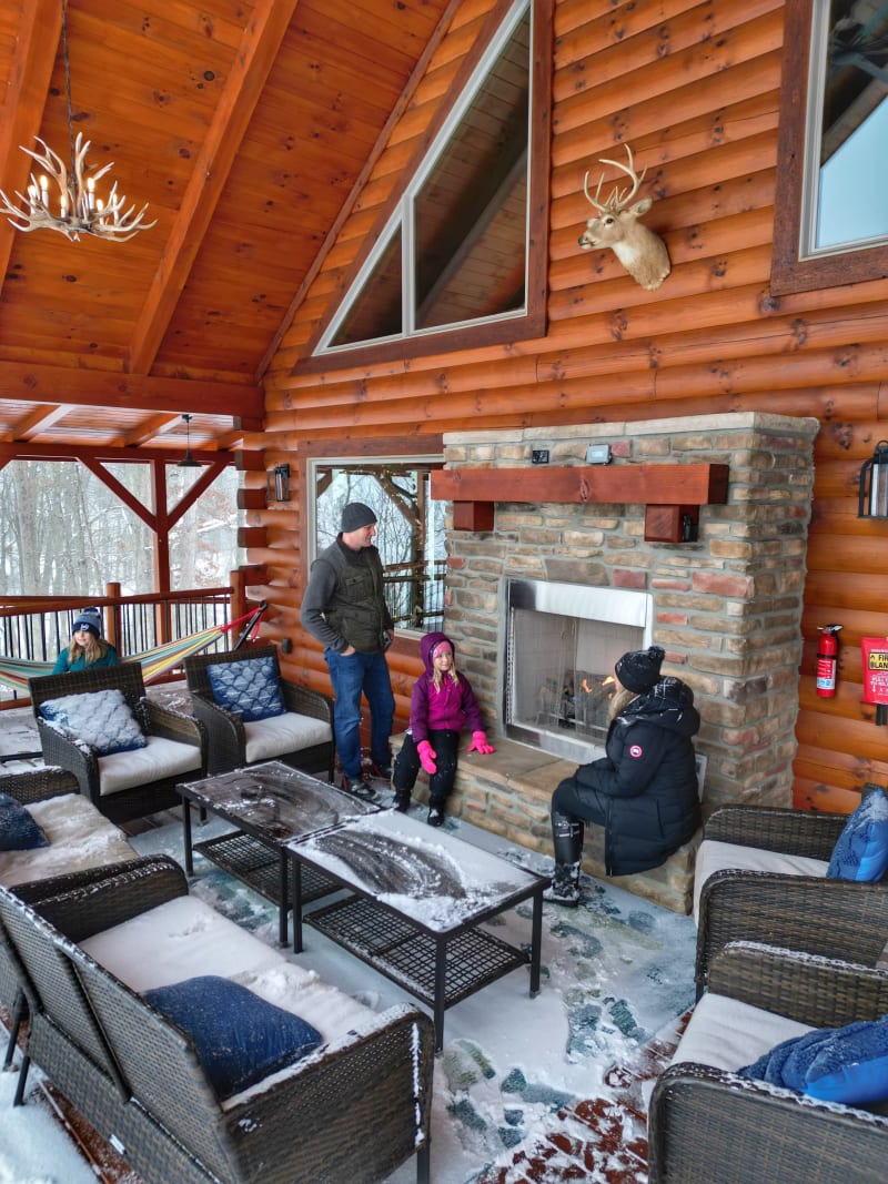 Pool house winter family on backporch fireplace