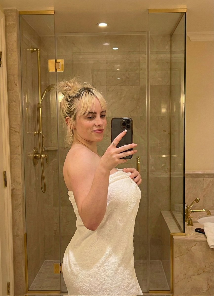 Sabrina Carpenter Mirror Selfie in a Luxurious Marble Bathroom example 2