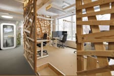 Rådmansgatan 16 - Arbetsplatser med trädetaljer intill mötesbås med glasdörr.