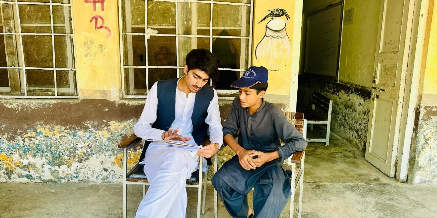 Picture of a boy participating in the project being interviewed during the impact measurement phase.