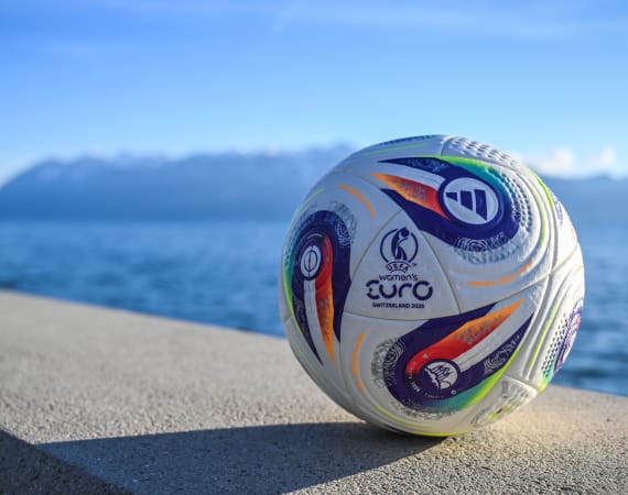 Women's EURO 2025 Final Tournament ball in front of a lake.