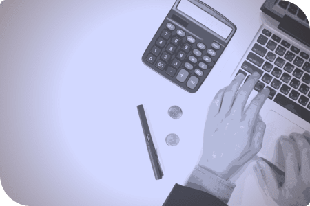 Una persona usa un teclado y un calculador para hacer cálculos.