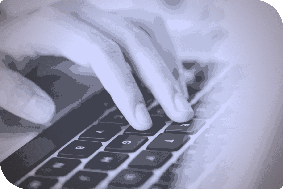 Uno de los dedos de una mano está presionando el teclado de un ordenador.