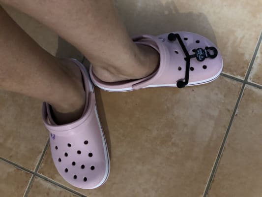 pink crocs on feet