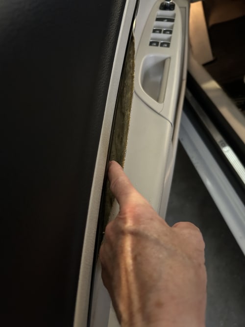 Purpose of reattaching material to door panel