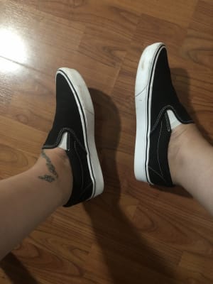 black slip on vans on feet