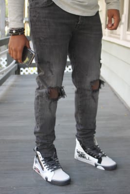 red and white high top vans on feet