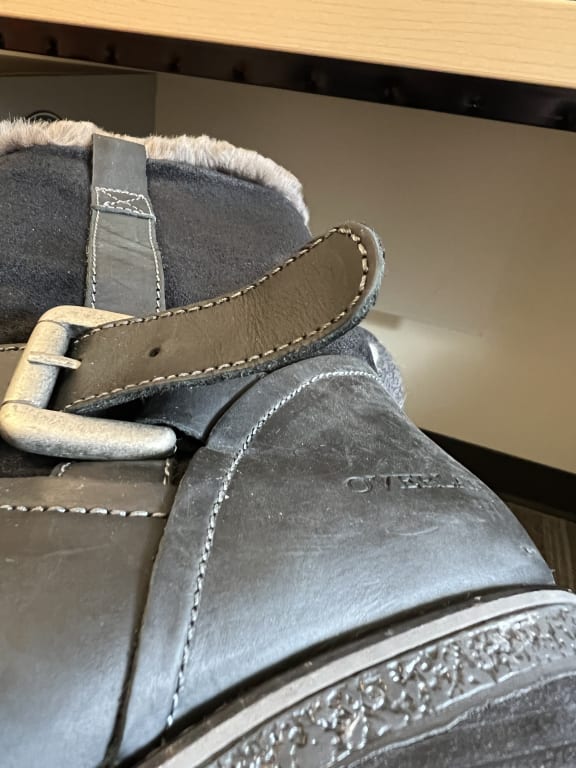 Customer Image Captioned: another angle of the boot with the strap sticking out because the strip to tuck it in is missing