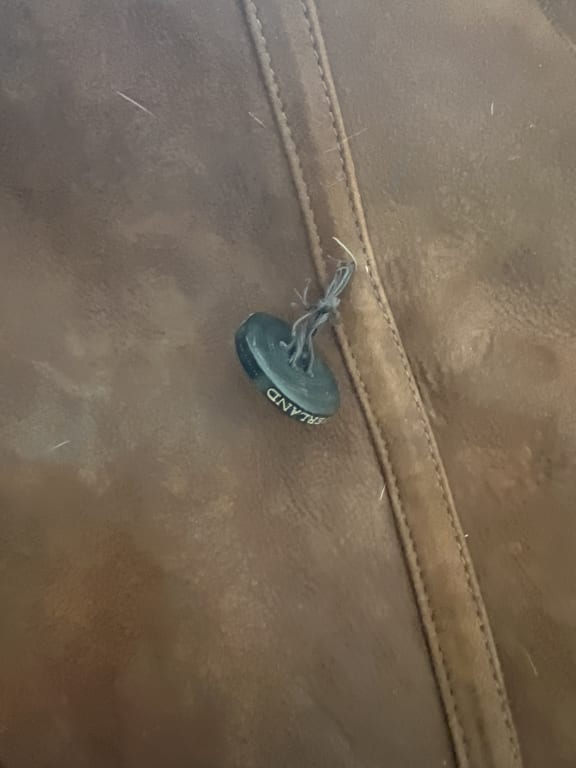 Customer Image Captioned: Button about to fall off