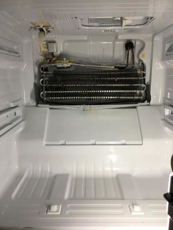 Old part not that bad but replaced anyway, no picture. Freezer section was not that bad and no food left inside like with the refrigerator. Picture of new parts with a coat of rust preventive glossy white paint.