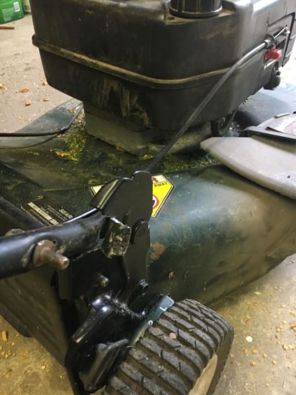 Note modification to bracket to provide clearance for handle