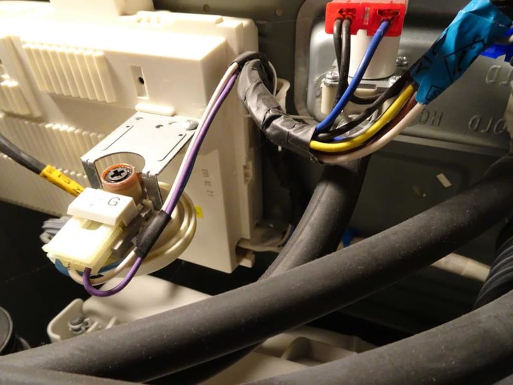 Remove three wire harness holders (small blue piece behind the two hoses).