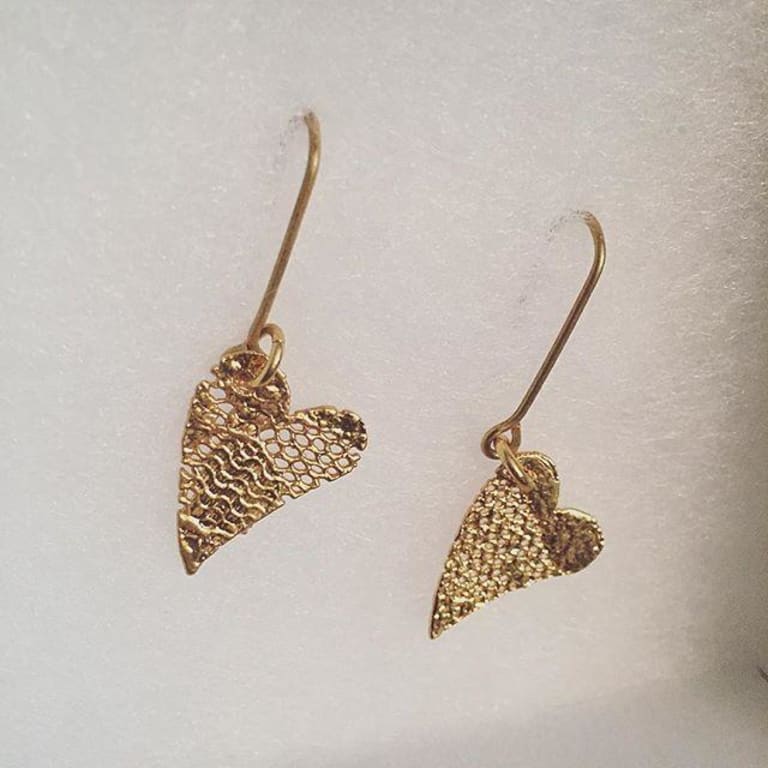 Mini Gold Dipped Lace Heart Earrings from Uncommon Goods. Customer submitted image.