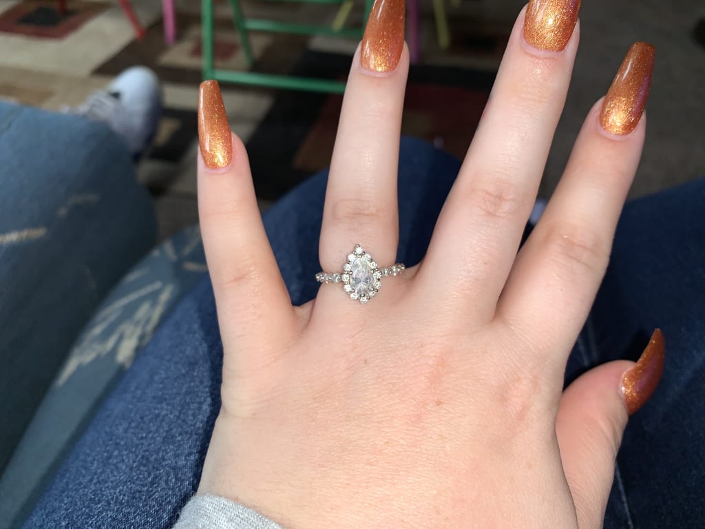 Oval diamond ring on hand