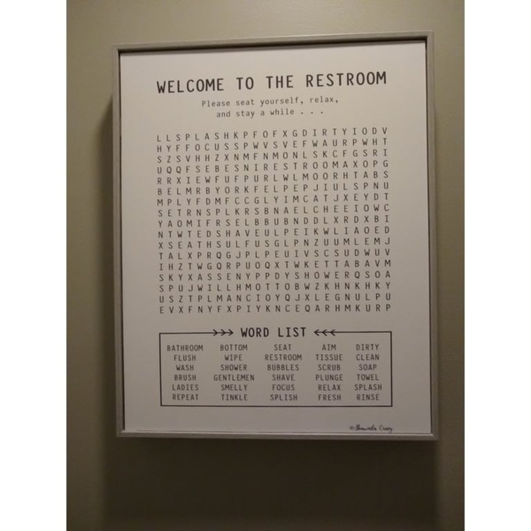 The Stupell Home Decor Black and White Restroom Crossword Puzzle Sign