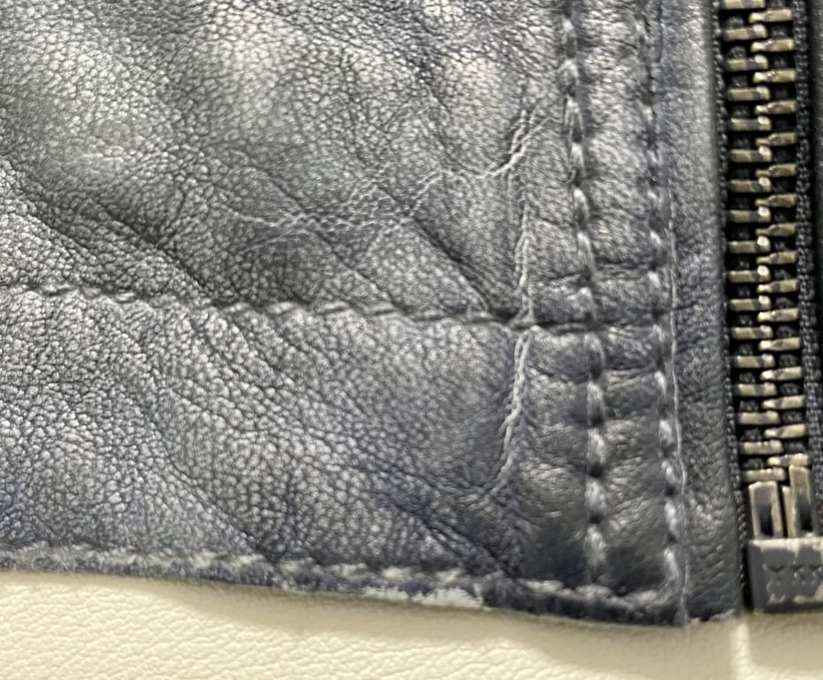 Customer Image Captioned: Lower left hem showing fraying and worn
