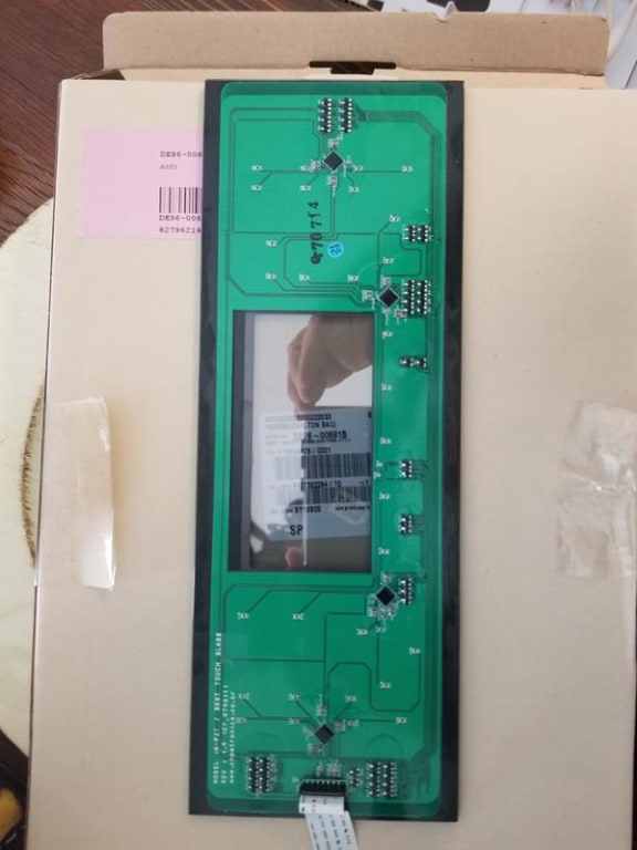 This is the original PCB still on the display glass. I took a photo to compare proper alignment. The replacement touchscreen is a peel-off adhesive. NOTE: The ribbon cable pulls straight out. My replacement came with a new ribbon cable. Suggest you use it