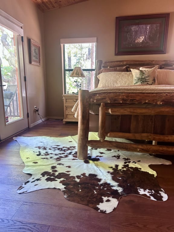 Customer Image Captioned: Cowhide rug-King size bedroom