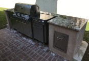 View of granite top and propane storage drawer